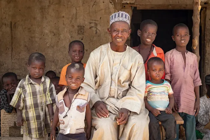 A local leader in Dala, Borno state, Nigeria, with his grandchildren and other kids who received vaccinations with UNICEF's support.