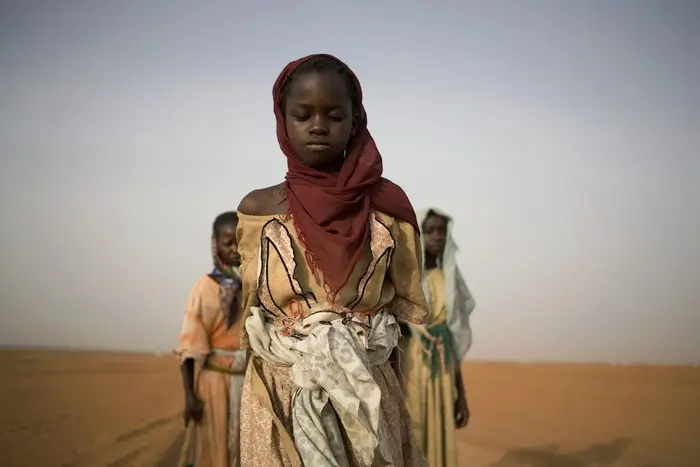 A UNICEF archival image of girls leaving a displacement camp to gather firewood in Darfur, Sudan, in 2005.