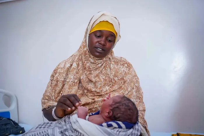 A mother in Somalia holds her newborn son, delivered in a UNICEF-supported facility.