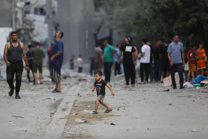 A child walks across a street in the Gaza Strip in October 2023.