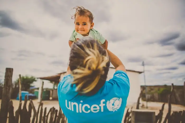 UNICEF staff member holds a young child in Bahia, Brazil.