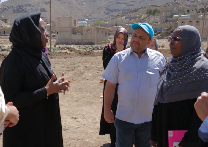 UNICEF Yemen Representative Sara Beysolow Nyanti (in black) visits solar panel network project in Ibb, Yemen.