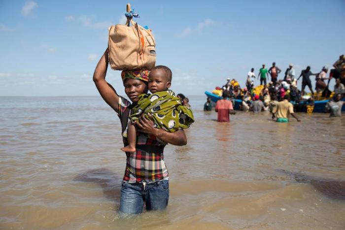 On March 29, 2019 in Mozambique, Dorinda Antonio and her son, Manuel, arrive by boat in Beira from Buzi, one of the areas most severely affected by Cyclone Idai. 