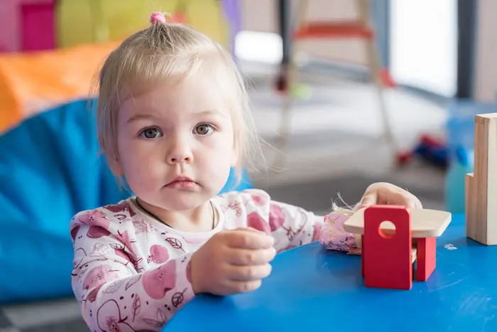 A child who has fled the war in Ukraine sits at a table inside a play space set up for children at a Blue Dot refugee support center in Romania. A child who has fled the war in Ukraine sits at a table inside a play space set up for children at a Blue Dot refugee support center in Romania.