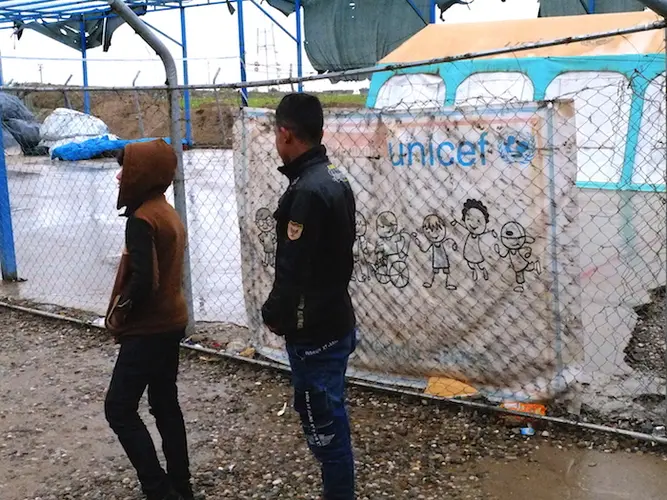 Aziz, 11, and Mahmoud, 17 (names changed), in front of their tent in Debaga camp in Iraq's Erbil Governate. 
