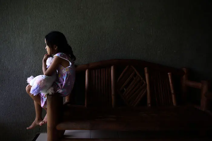 This 8-year-old girl and her six siblings were rescued during a cyber crime police raid when their parents were caught forcing the two oldest sisters to participate in live streaming of child sexual abuse in their home.