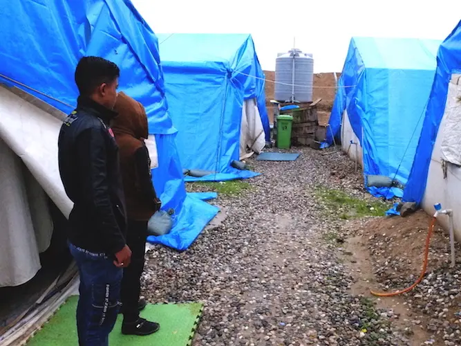 Aziz, 11, and Mahmoud, 17 (names changed), in front of their tent in Debaga camp.