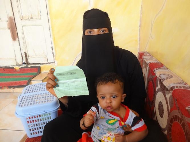 Arwein Ahmed, 26, holds the paper indicating she was vaccinated against tetanus by UNICEF-supported health workers when she was pregnant with her son, Abdulrahman, who was born healthy as a result. 