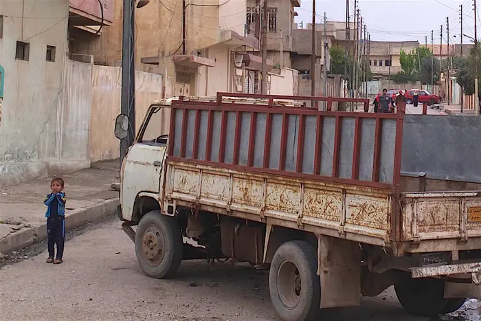 A child stands in the streets of eastern Mosul, Iraq.