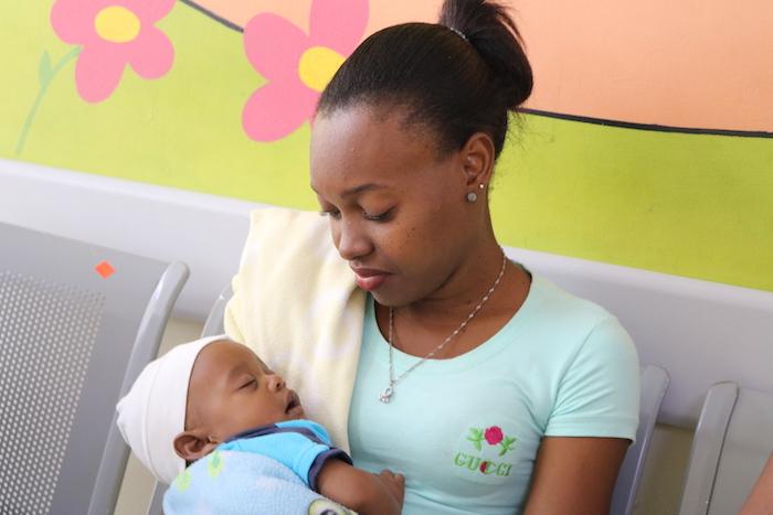 A new mother cradles her sleeping baby at San Lorenzo do Los Mina Maternal and Infant Hospital in Santo Domingo, Dominican Republic in February 2019. 