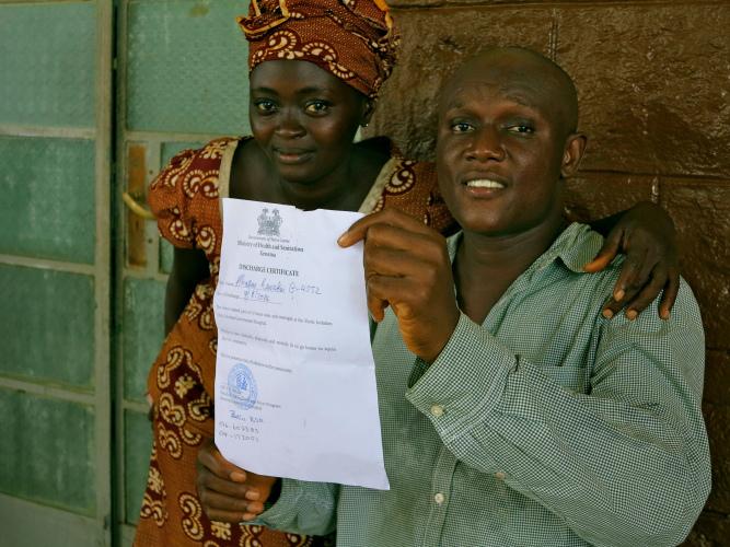Alhassan holds up his discharge certificate. (c) UNICEF Sierra Leone/2014/Dunlop