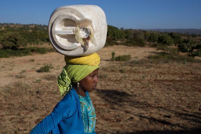Seudi, 12,carries water back to her family home in a village outside Harar, Ethiopia in 2015. 