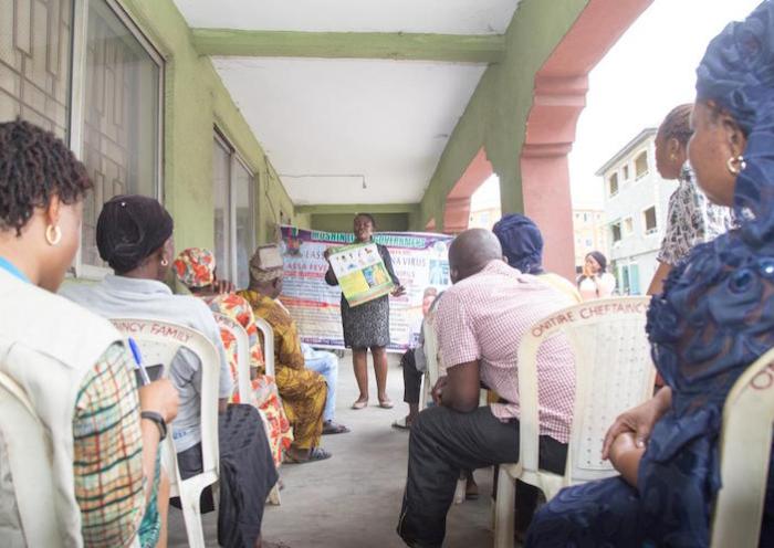 A UNICEF-supported health worker shares best practices for fighting the spread of COVID-19 with a group in Lagos, Nigeria in March 2020.