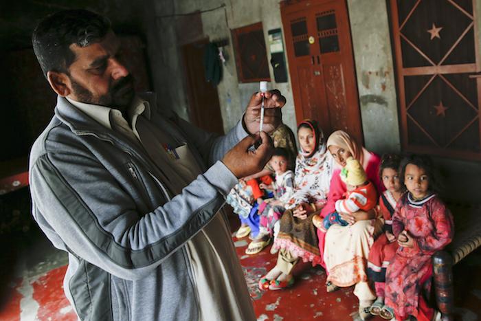 Farrukh, a government vaccinator makes PCV 10 (vaccine for pneumonia) for a child during a field visit in Bahder wala village in Nankana District, Punjab province, Pakistan.