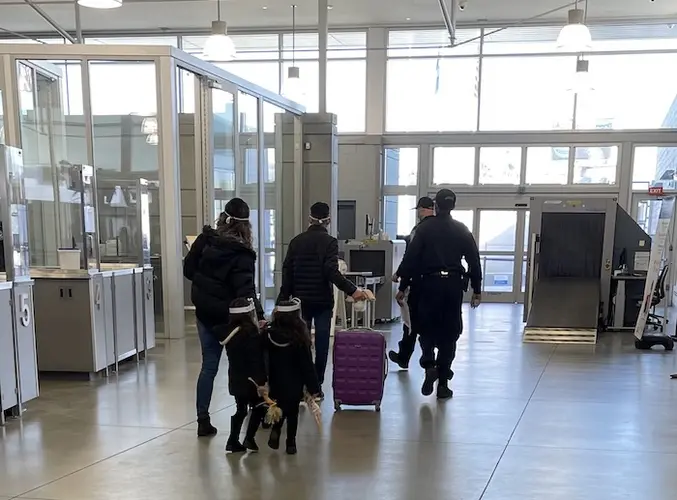 A family previously enrolled in MPP approaches the border, where they will be allowed to continue pursuing their asylum case while in the U.S..