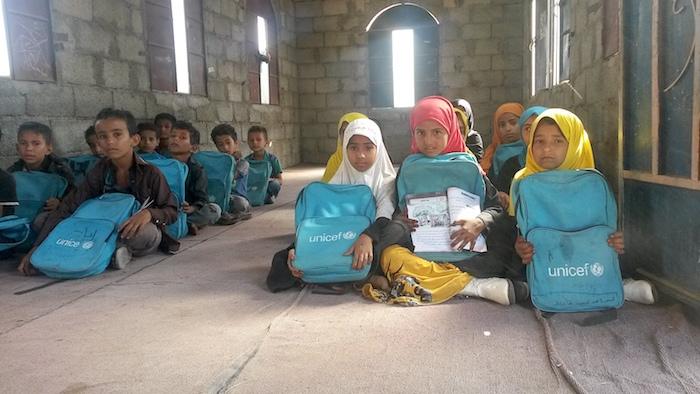 Third grade students, aged between 8 and 10, who received school bags from UNICEF, sit in a temporary classroom in Taiz, Yemen in March 2017.