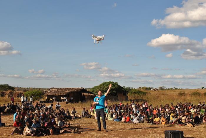Locals observe UNICEF's Drone Corridor Lead Michael Scheibenreif as he pilots an unmanned aerial vehicle in the UNICEF supported test corridor in Malawi.