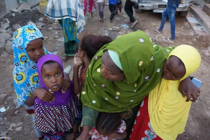 Mariam Kako, center, a UNICEF-trained volunteer working to end FGM in Djibouti, with some of the young girls she is working to protect. 