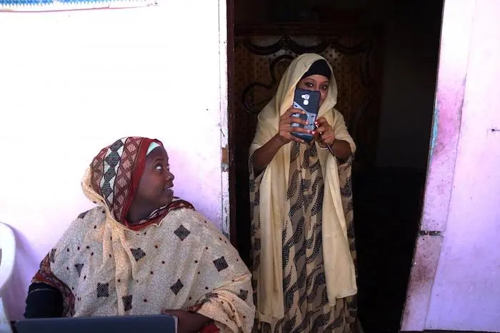 Mariam Kako, left, is a UNICEF-trained volunteer in Djibouti who works with mothers like Aicha to persuade them not to subject their daughters to FGM.