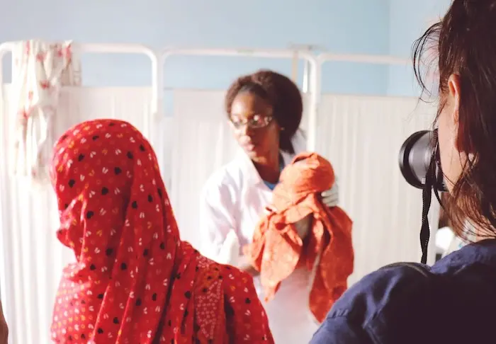 Midwife Gloria holds a newborn baby at a health clinic in Banki, Nigeria.