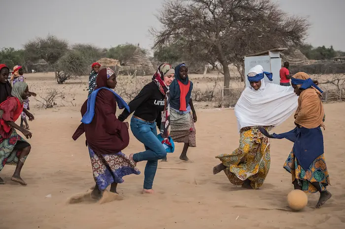 Syrian refugee and education activist Muzoon Almellehan, UNICEF&#039;s youngest goodwill ambassador, plays football with Nigerian refugees in Dar es Salam refugee camp, Chad.