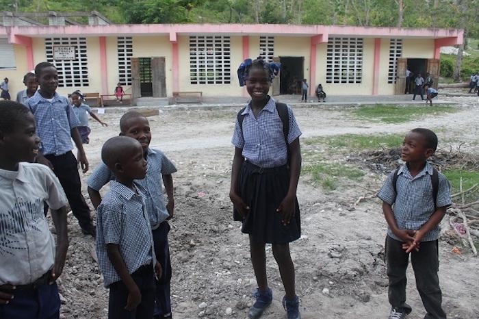 Thirteen-year-old Roseberline, center, was elated to return to her school after it was damaged by Hurricane Matthew and rebuilt with support from UNICEF. 