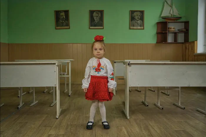 A child stands in her school after witnessing parts of it completely destroyed A child stands in her school after witnessing parts of it completely destroyed