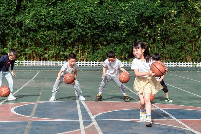 Kindergarteners play basketball in Chongqing, China. After implementing a series of safety measures following the outbreak of COVID-19, schools reopened and children returned to learning and playing with classmates. Shop UNICEF Inspired Gifts