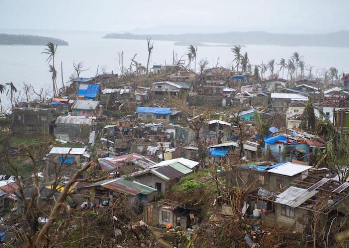 After the onslaught of Super Typhoon Rai (known as Odette locally), residents of San Jose, Dinagat Islands province, had to rebuild their houses with the debris that littered the streets. Roofs with mismatching parts are a common sight all over the town.