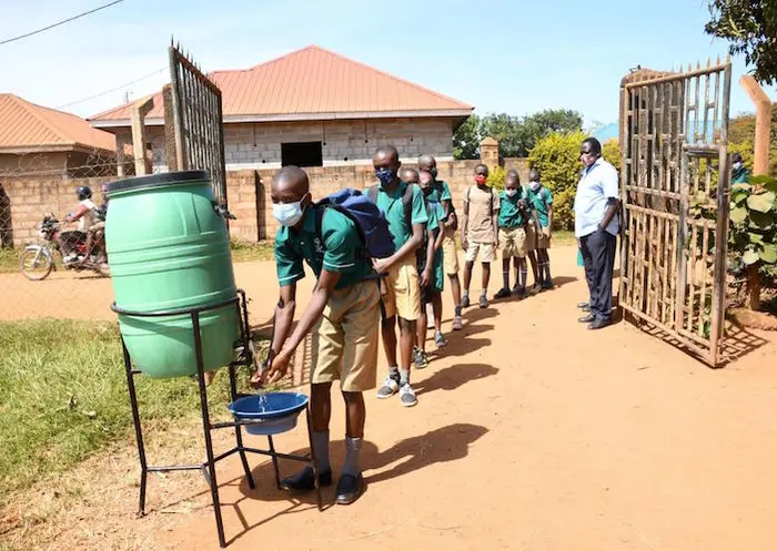 At Katabi Primary School in Entebbe, pupils must wash their hands before entering the school premises. Schools in Uganda were fully or partially closed for more than 83 weeks, reopening in January 2022. At Katabi Primary School in Entebbe, pupils must wash their hands before entering the school premises. Schools in Uganda were fully or partially closed for more than 83 weeks, reopening in January 2022.