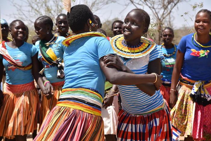 Girls and women from Ausikioyon village in Uganda's Amudat District celebrate after their village made a public declaration against female genital mutilation in 2017. 