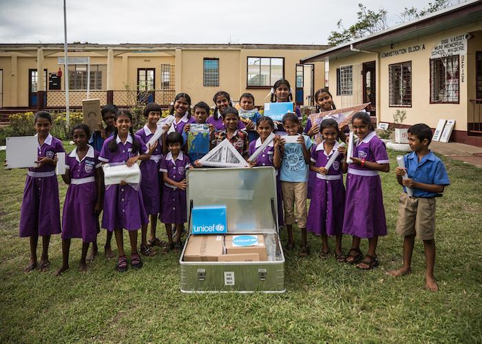 Students of Vasist Muni Municipal School in Fiji display the contents of a School-in-a-Box kit provided by UNICEF in March, 2016. 