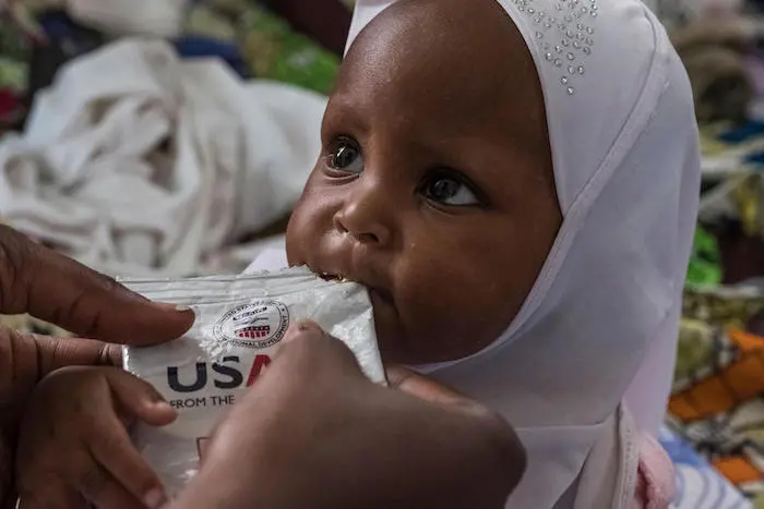 Douyassi, 2, is fed from a pack of Ready-to-Use Therapeutic Food at the nutrition ward of the Bangui Pediatric Hospital in Bangui, Central African Republic. 