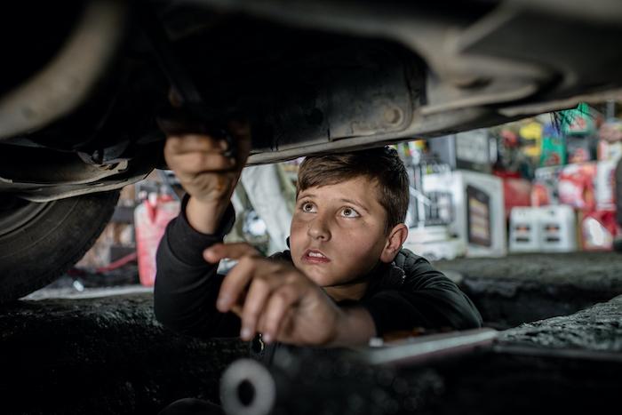 Mohammed, 14, a Syrian refugee from Kobani, works at a car repair shop in Erbil in the Kurdistan region of Iraq. 