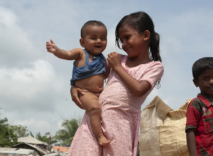 Rohingya refugee children Umma, 5, and her 5-month-old baby brother live in a refugee camp in Cox's Bazar, Bangladesh.