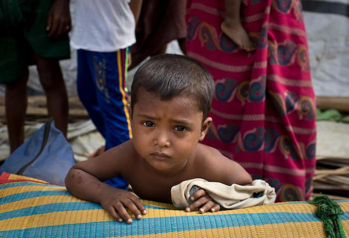 Mohammed, 4, waits with his family to be relocated to a safer landslide and flash flood-free zone of the Balukhali-Kutupalong refugee camp in Cox's Bazar, Bangladesh.