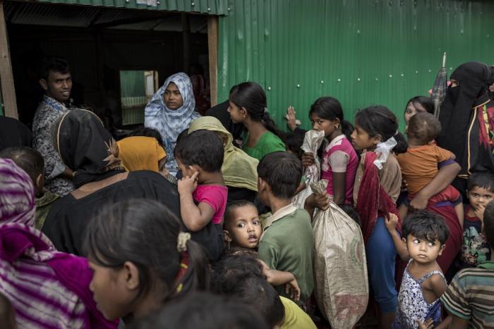 On 1 August 2018 in Cox's Bazar in Bangladesh, Rohingya women and children wait to receive aid from the one of the many aid distribution aid stations in the Unchiprang refugee camp.