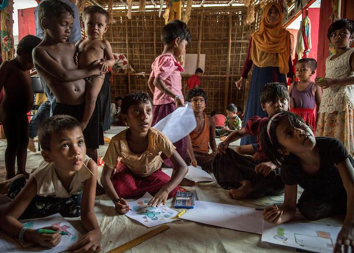 Rohingya refugee children draw pictures in a UNICEF Child-Friendly Space in BaluKali Camp 1, Bangladesh in September 2018. 