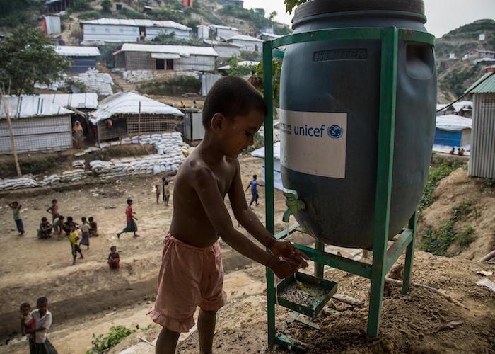 A Rohingya boy washes his hands at a UNICEF water point in Unchiprang refugee camp, Cox's Bazar district, Bangladesh.