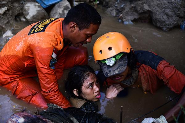 Nurul Istikhoroh (15) is evacuated by the Basarnas team at the Balaroa National Park in West Palu, Central Sulawesi, after almost 48 hours of being trapped in the rubble of their house and being submerged in water after the earthquake and tsunami that str