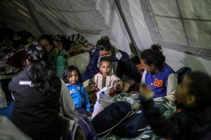 Migrant children and mothers gather at a UNICEF temporary rest tent in Rumichaca, Ecuador on the border with Colombia.