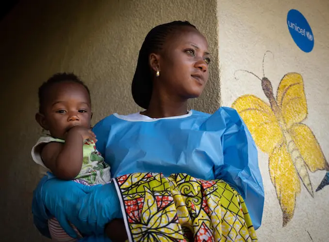 Jemima, an Ebola survivor, cares for 6-month-old Josué at a UNICEF-supported child care center in Beni, Democratic Republic of the Congo, in December 2018.