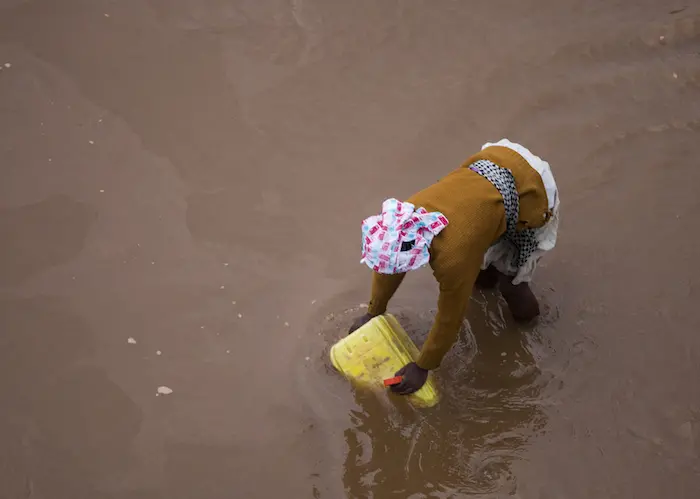 A woman draws water from a river in southern Madagascar. UNICEF and partners are working to improve access to safe drinking water and sanitation services and put an end to open defecation in Madagascar and other countries around the world.
