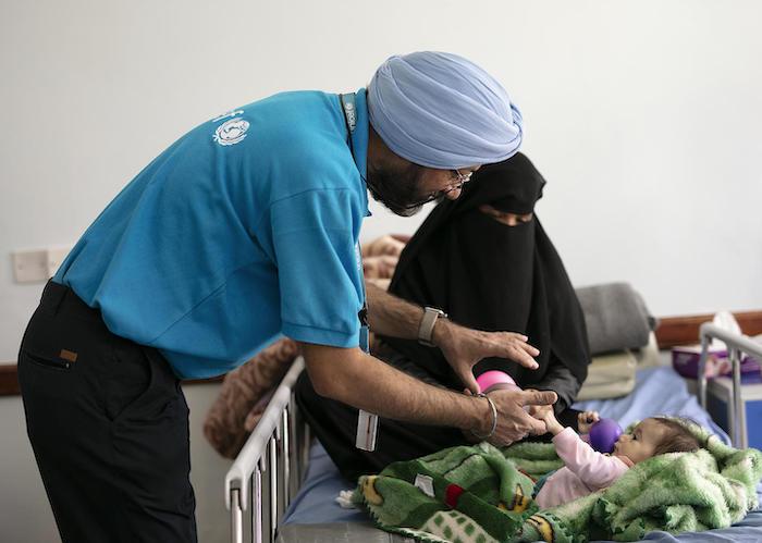 UNICEF Nutrition Manager Karanveer Singh cares for a malnourished child in Sana'a, Yemen in October 2018. 