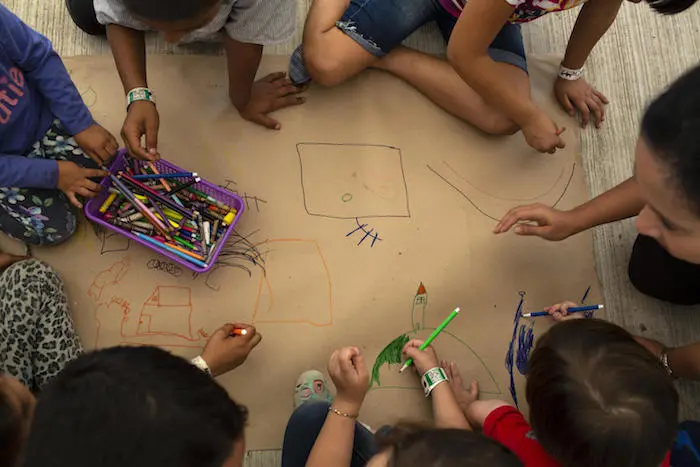 Migrant children awaiting their humanitarian visas draw pictures of the homes they fled at the UNICEF-supported Child-Friendly Space at the Mexico-Guatemala border in Ciudad Hidalgo, Mexico, on January 29, 2019.