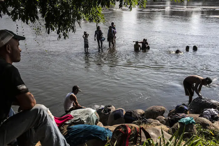 Migrant families wash clothes in the Suchiate River at the Mexico-Guatemala border in Ciudad Hidalgo, Mexico, on January 31, 2019. 