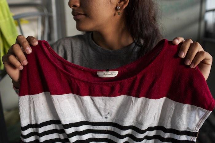 Nelsy Saray Castillo Briones, 16, from Honduras, holds up the t-shirt she brought with her to wear in America, at a UNICEF-supported shelter for unaccompanied migrant girls, the Albergue Municipal de Ninas y Adolescentes Migrantes de Tapachula, in Tapachu