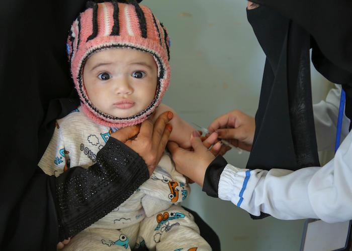 A child is vaccinated at a health center in Bani Alhareth, Sana'a, Yemen during a UNICEF-backed measles and rubella vaccination campaign in February 2019.