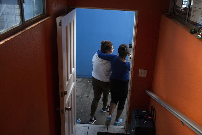 Two teens from Central America walk out of an open-door shelter for unaccompanied migrant adolescents in Mexico.