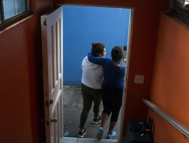 Two teenage girls from Central America connect at an open shelter for unaccompanied migrant adolescents in Tijuana, Mexico.